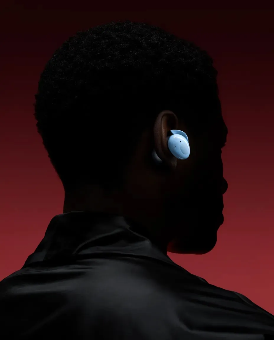 Product shoot: silhouette wearing an earbud on a deep red background