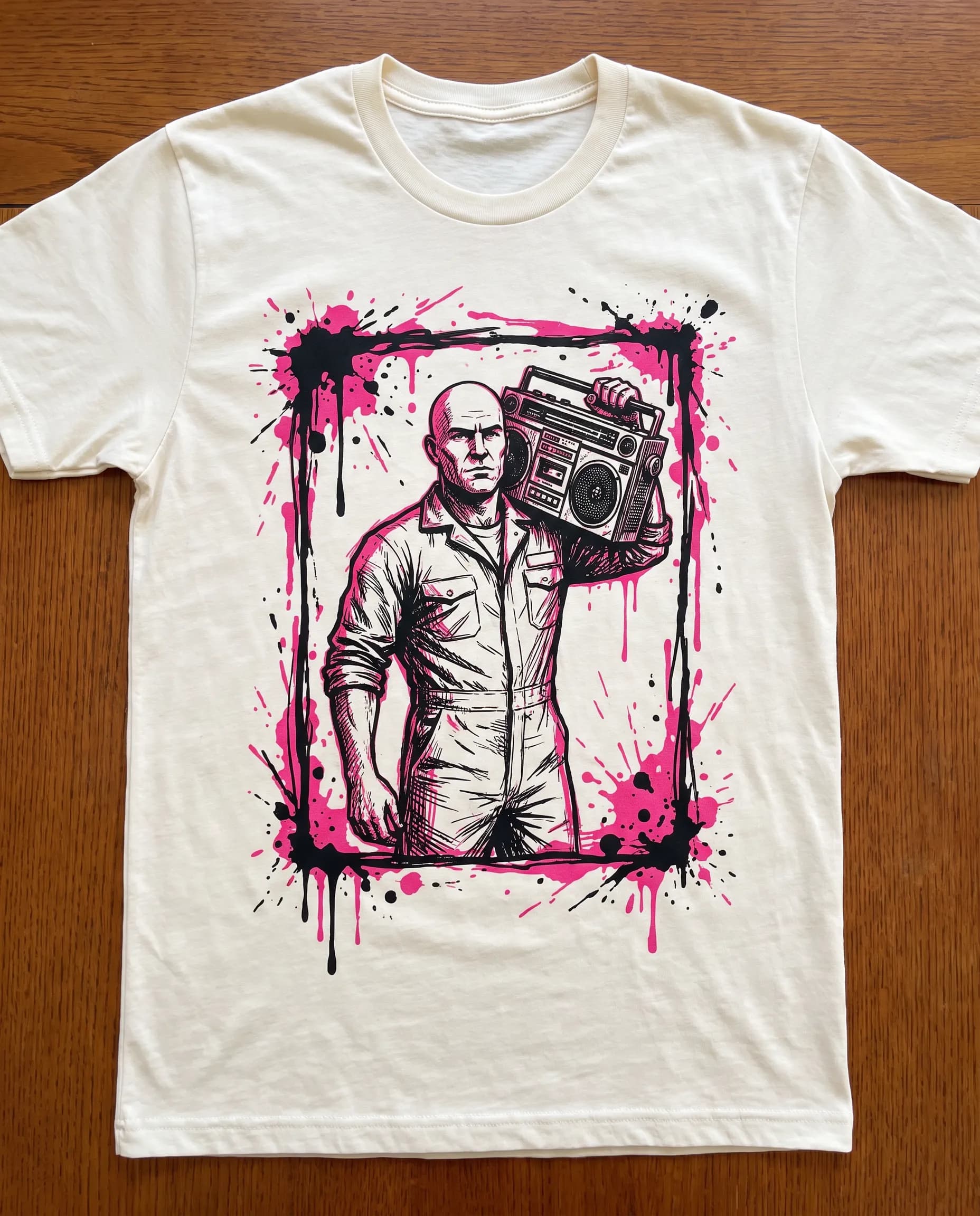 Two-color T-shirt graphic of an adult scrapyard mechanic shouldering a boombox, Gachiakuta art style