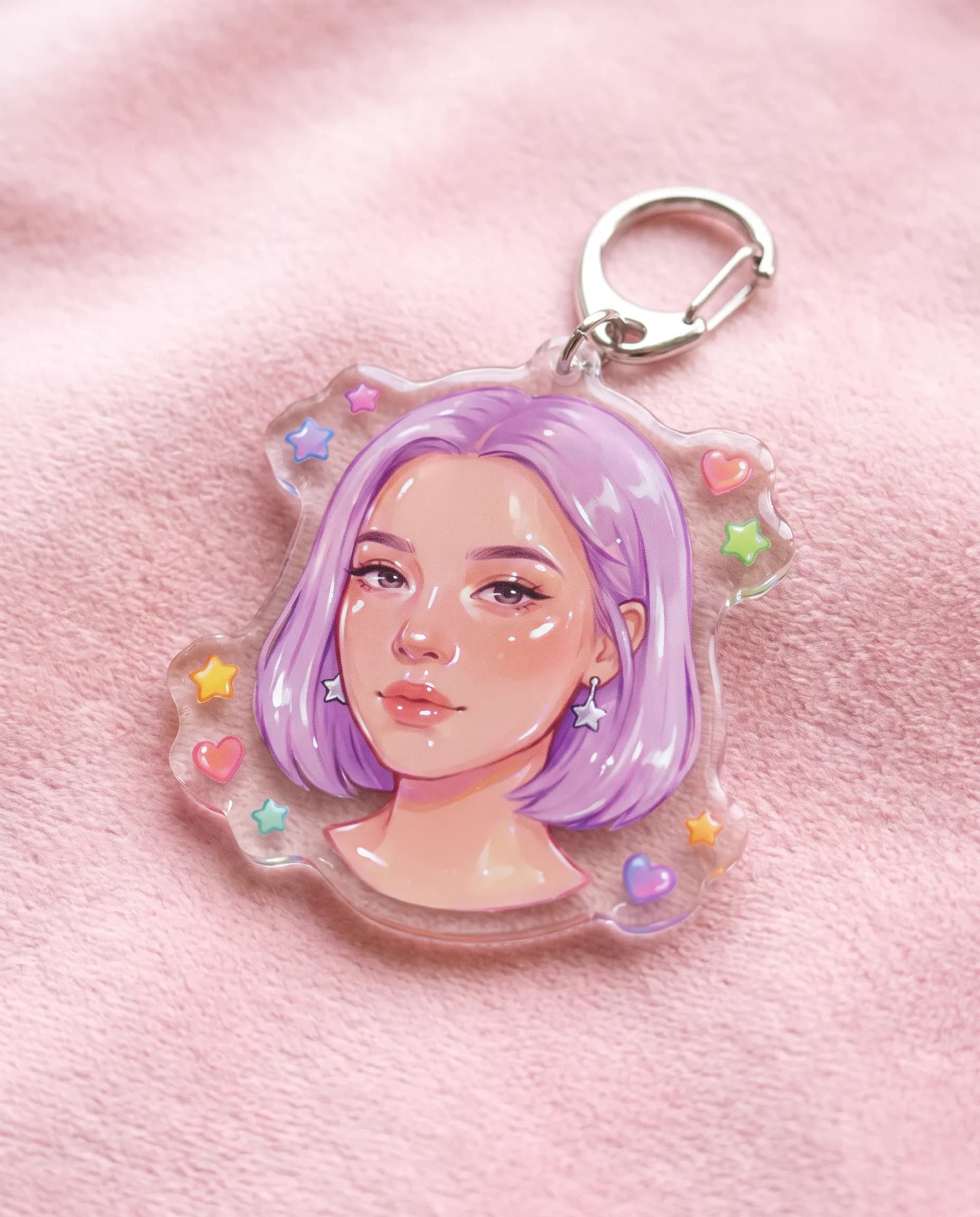 Clear acrylic keychain charm printed with a young woman with a lilac bob and silver star earrings in jelly art style
