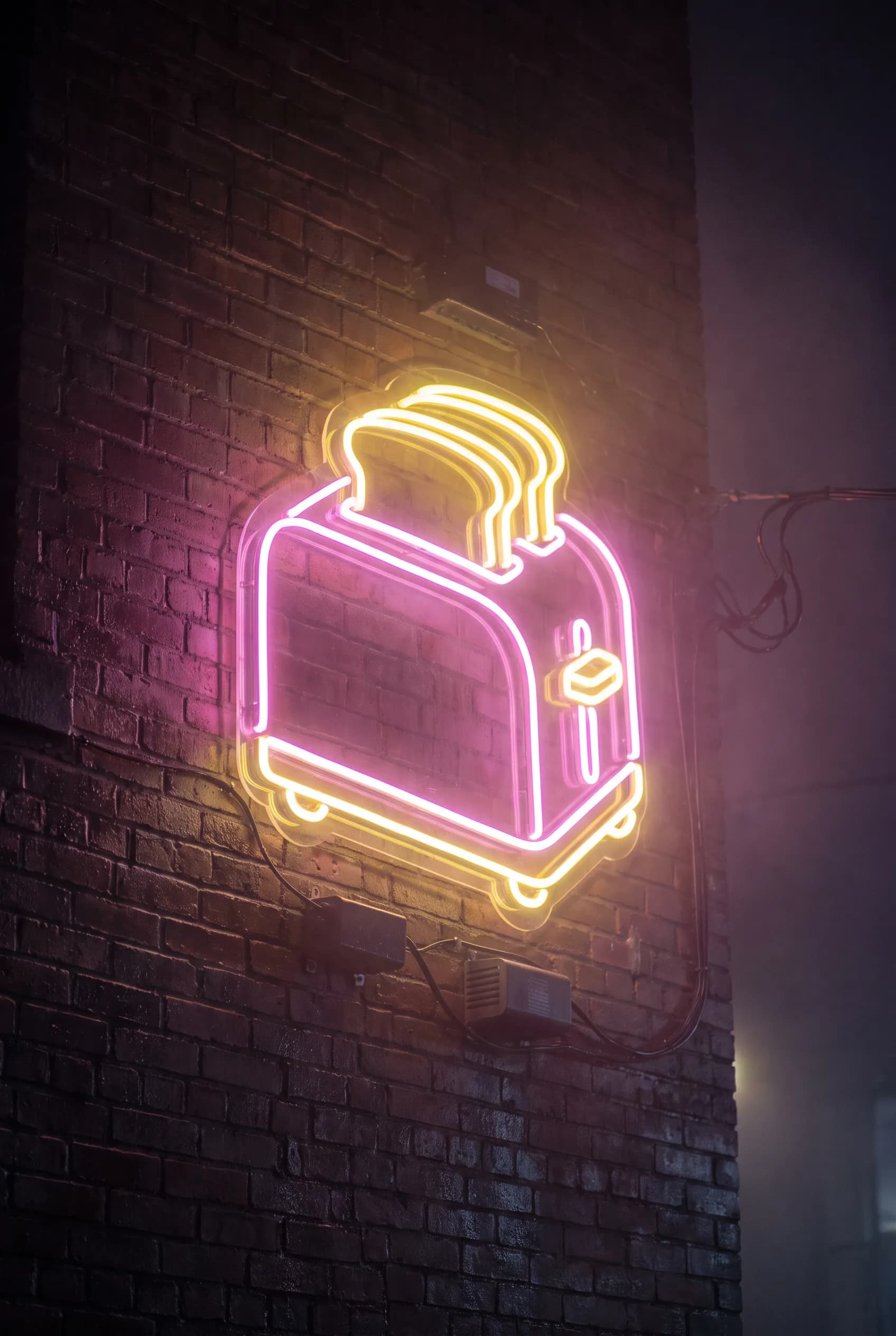 Neon sign shaped like a pop-up toaster with two slices of toast
