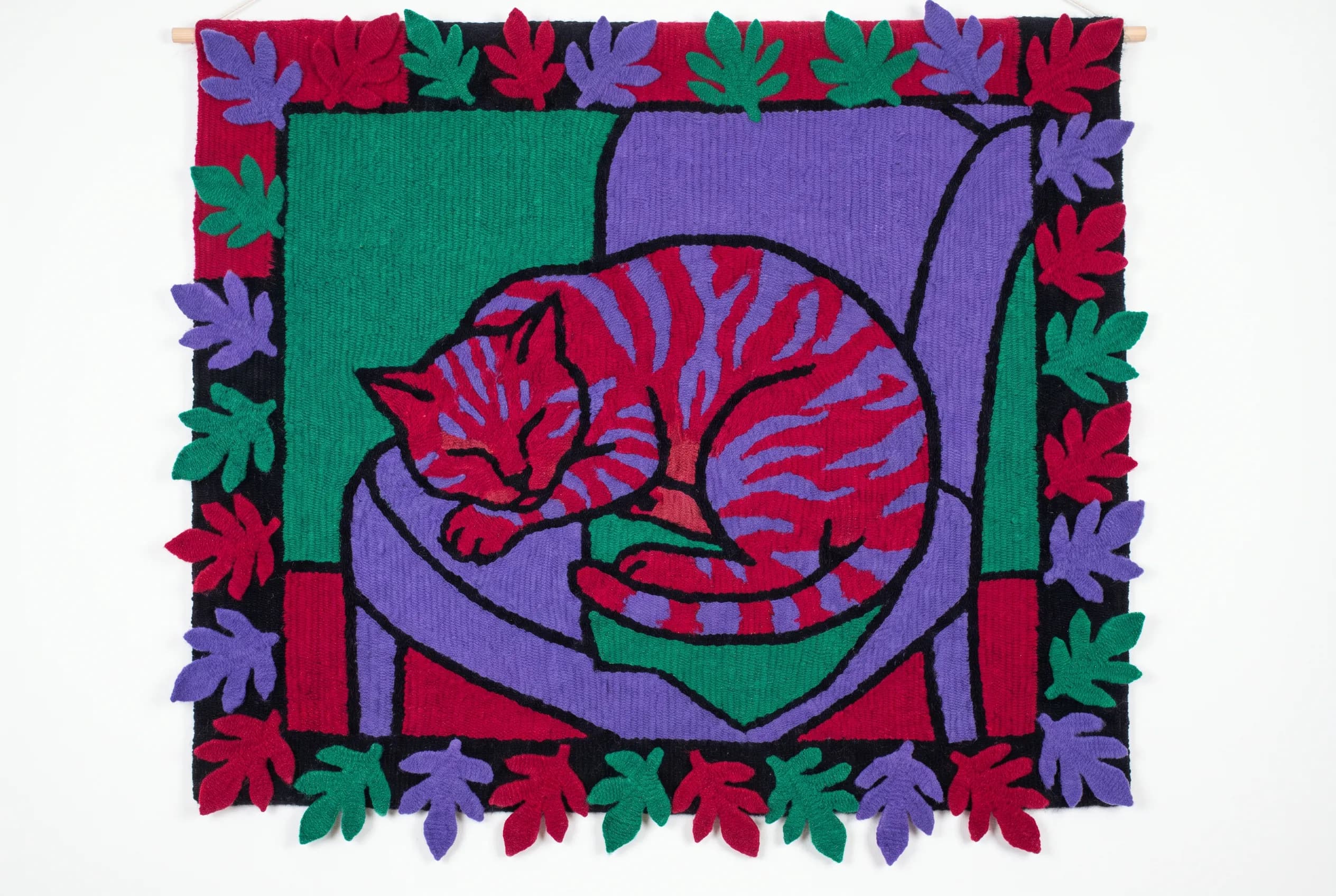 Woven wool wall hanging of a tabby cat asleep on an armchair, Henri Matisse art style