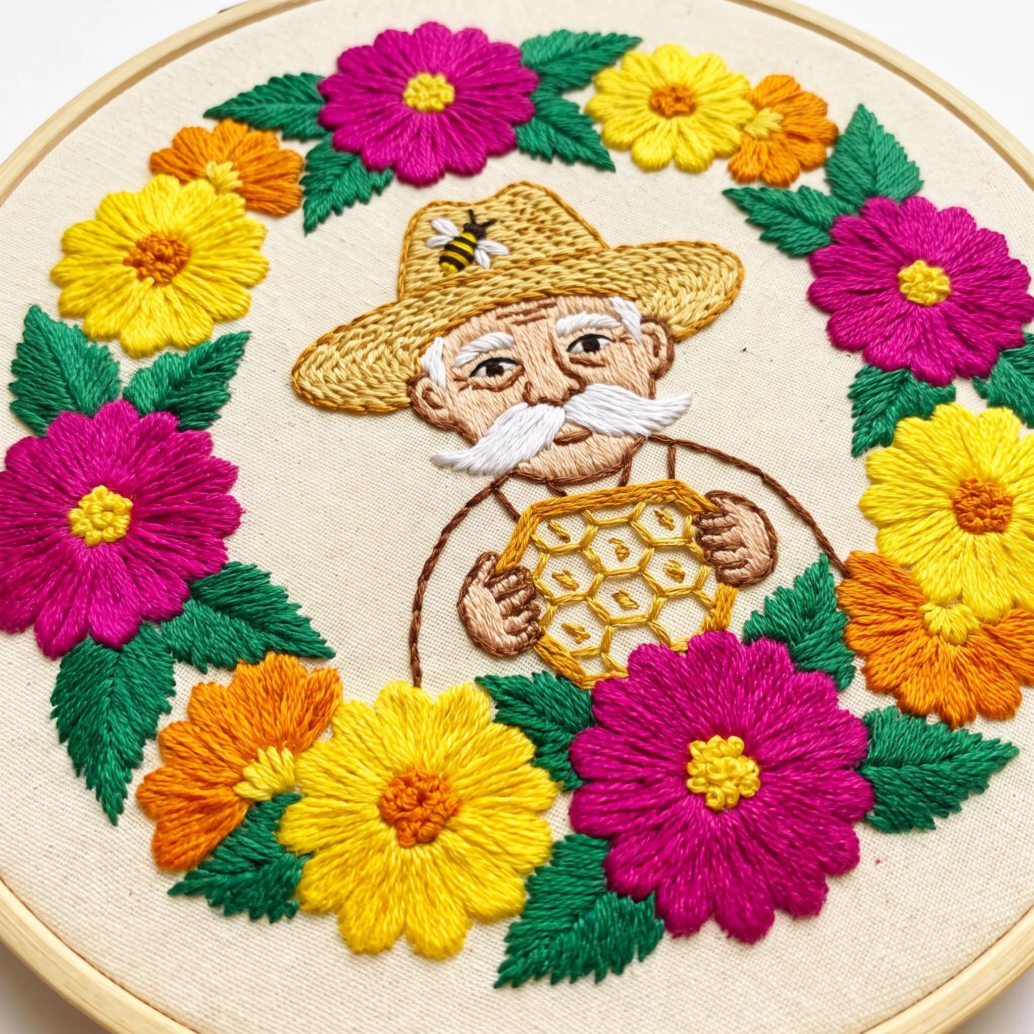 Satin-stitch embroidery of an elderly beekeeper framed by marigolds, Frida Kahlo art style