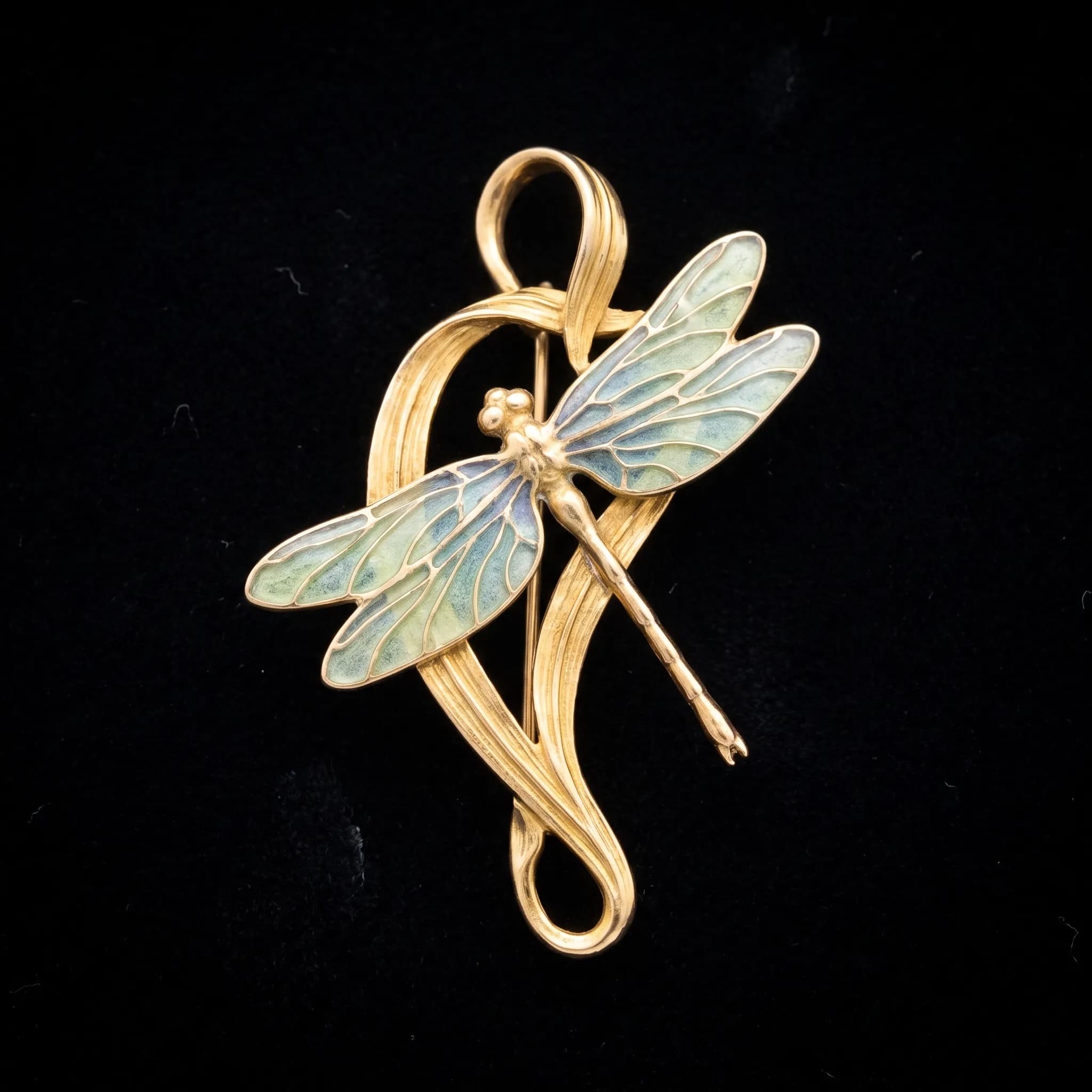 Gold and translucent enamel pendant shaped like a dragonfly perched on an iris stalk