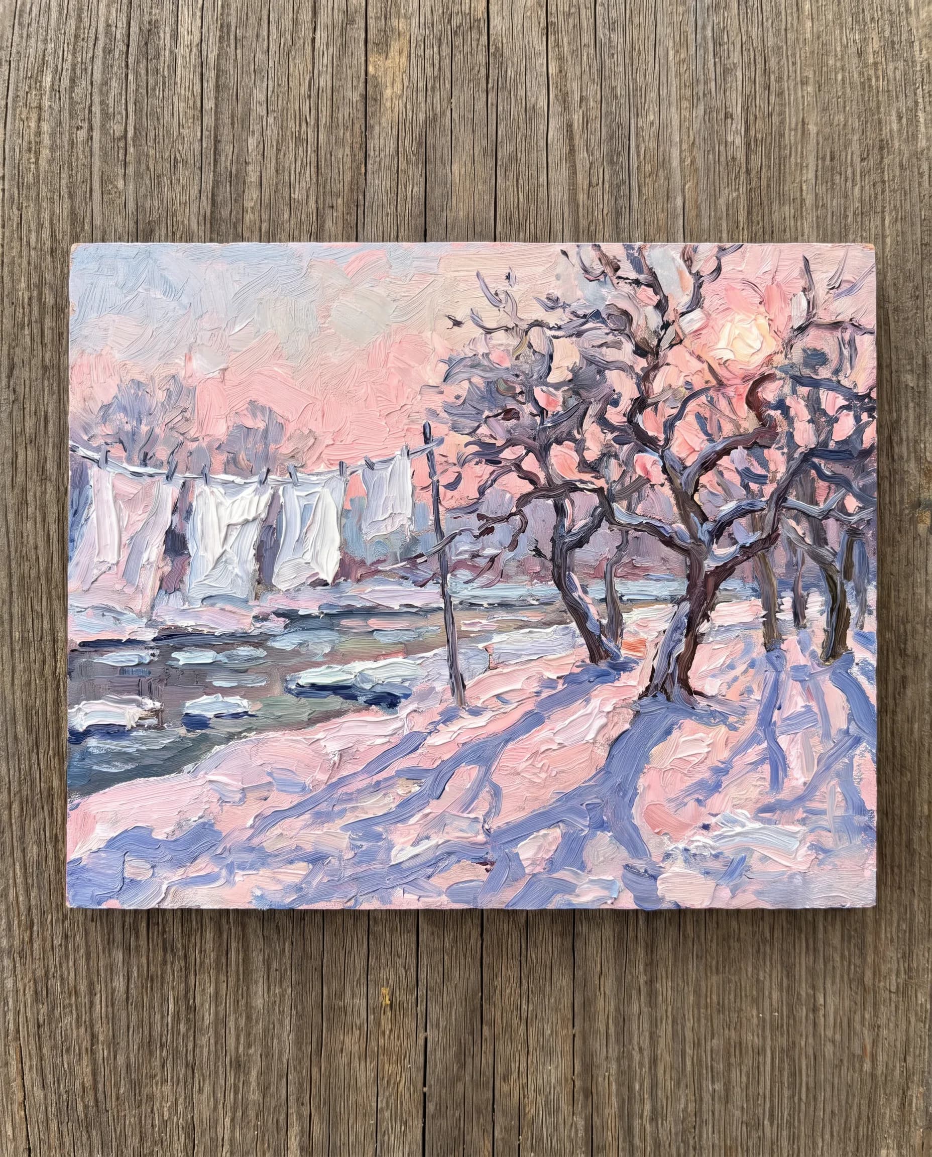 Small oil sketch of frozen sheets on a line in a snowy riverside orchard at sunrise, Claude Monet art style