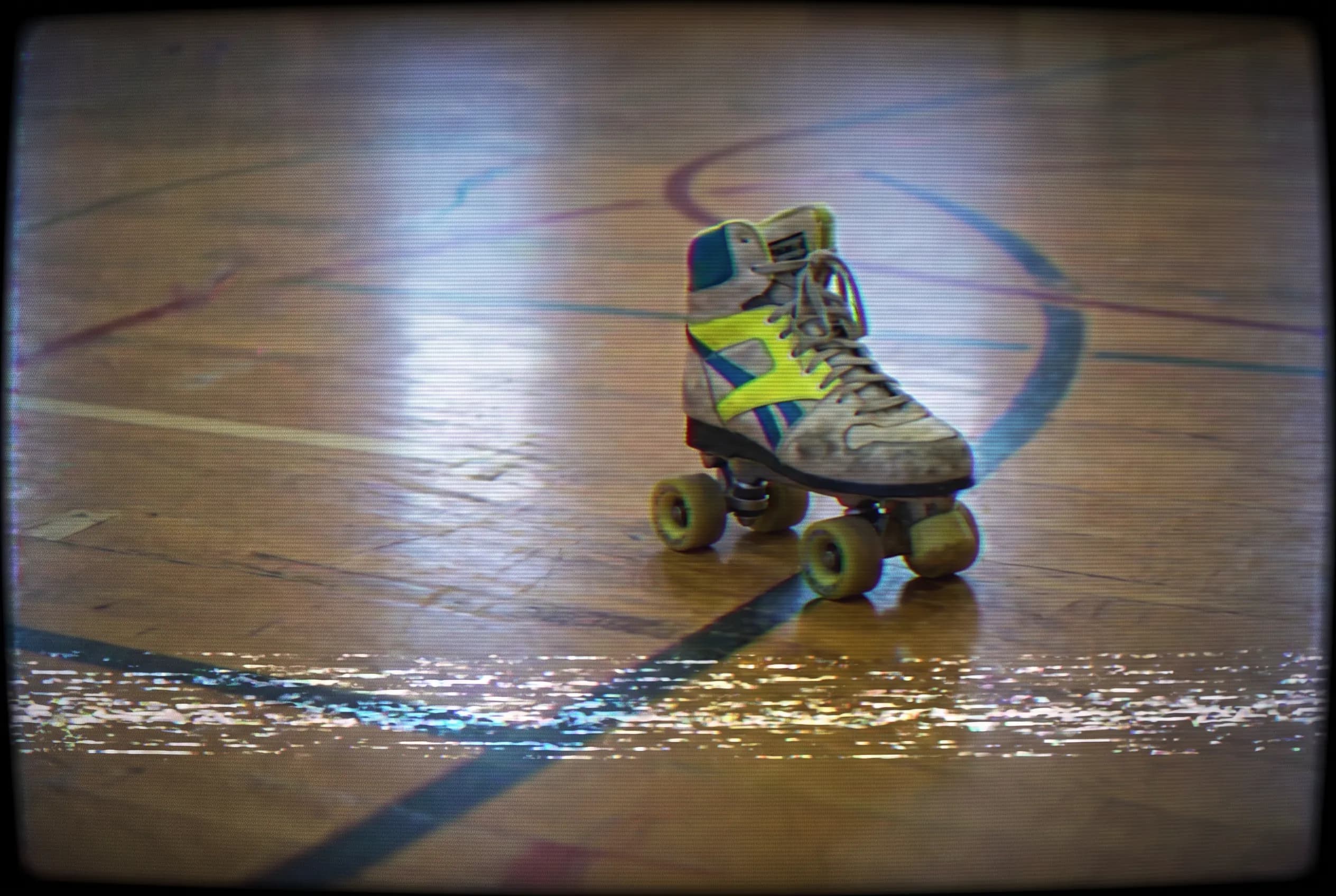 VHS still frame of a roller skate rolling across a gym floor with scanlines, 80s art style