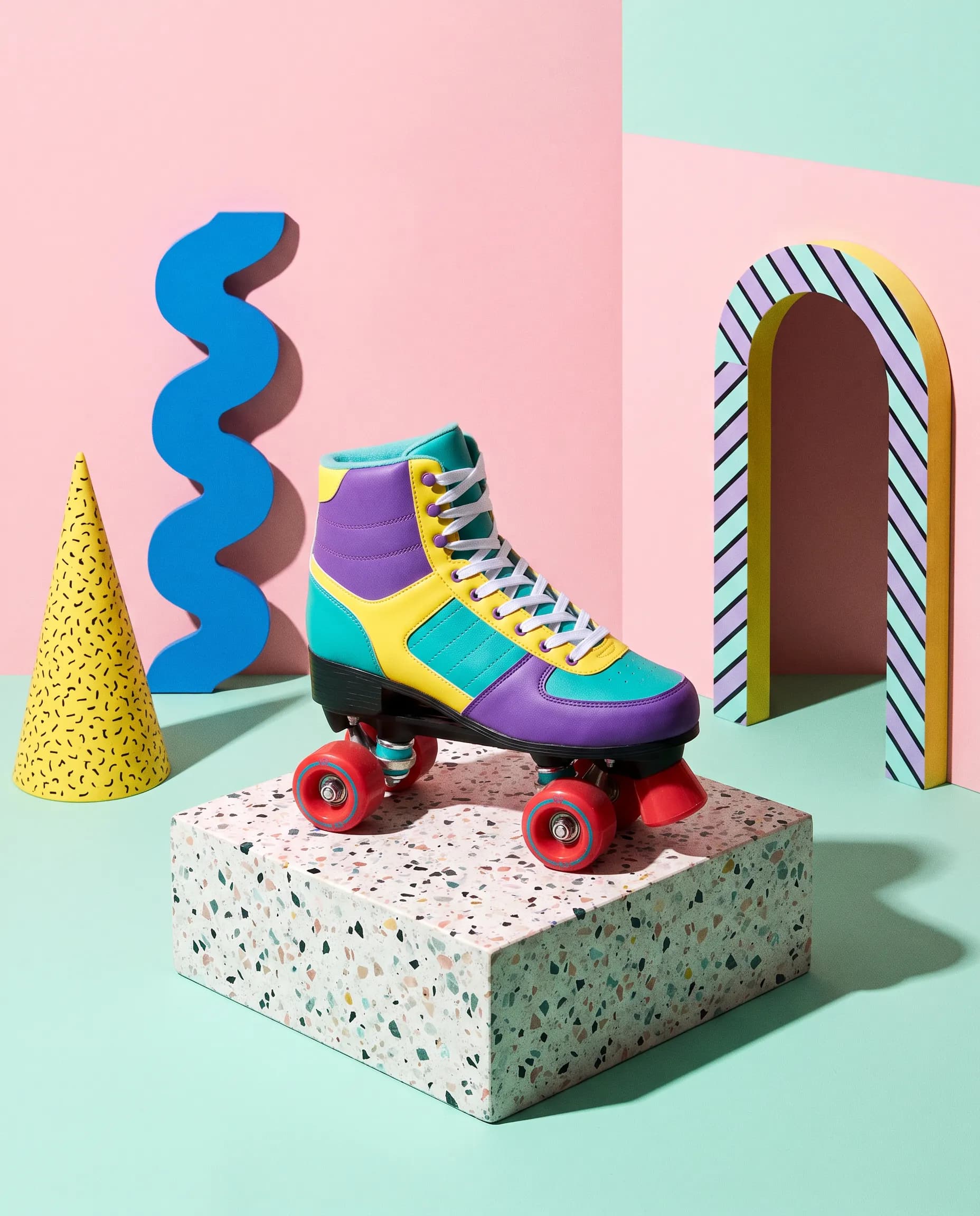 Studio photo of a roller skate on a terrazzo plinth with Memphis props, 80s art style